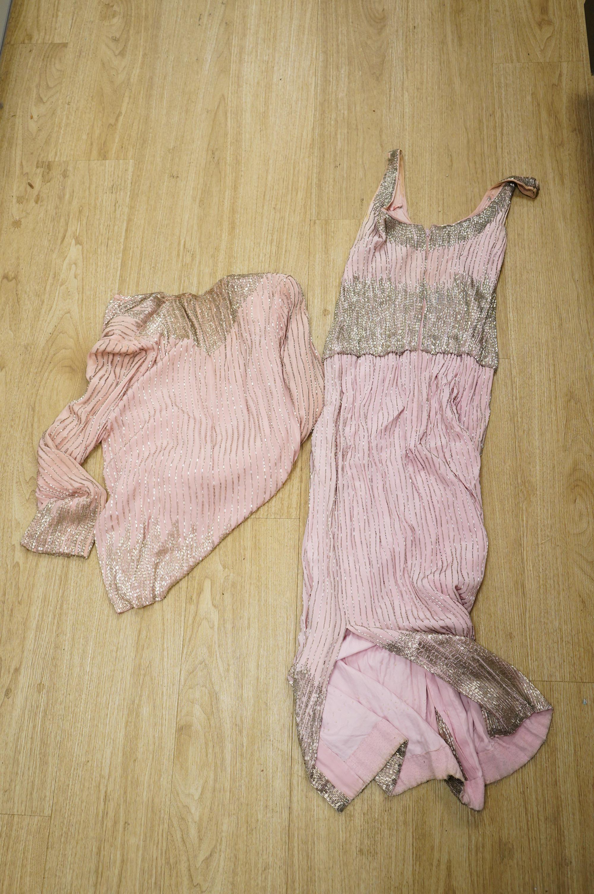 A mid to late 20th century pink and silver beaded evening dress-120cm long, with matching jacket, together with a green net beaded full length evening dress with mushroom lining and back split.